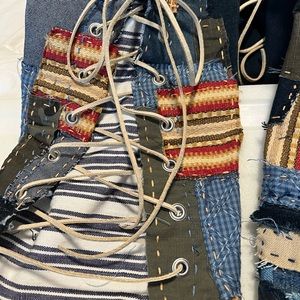Artisan boho/hippie denim jeans with patchwork bell bottoms/ rawhide lace up.